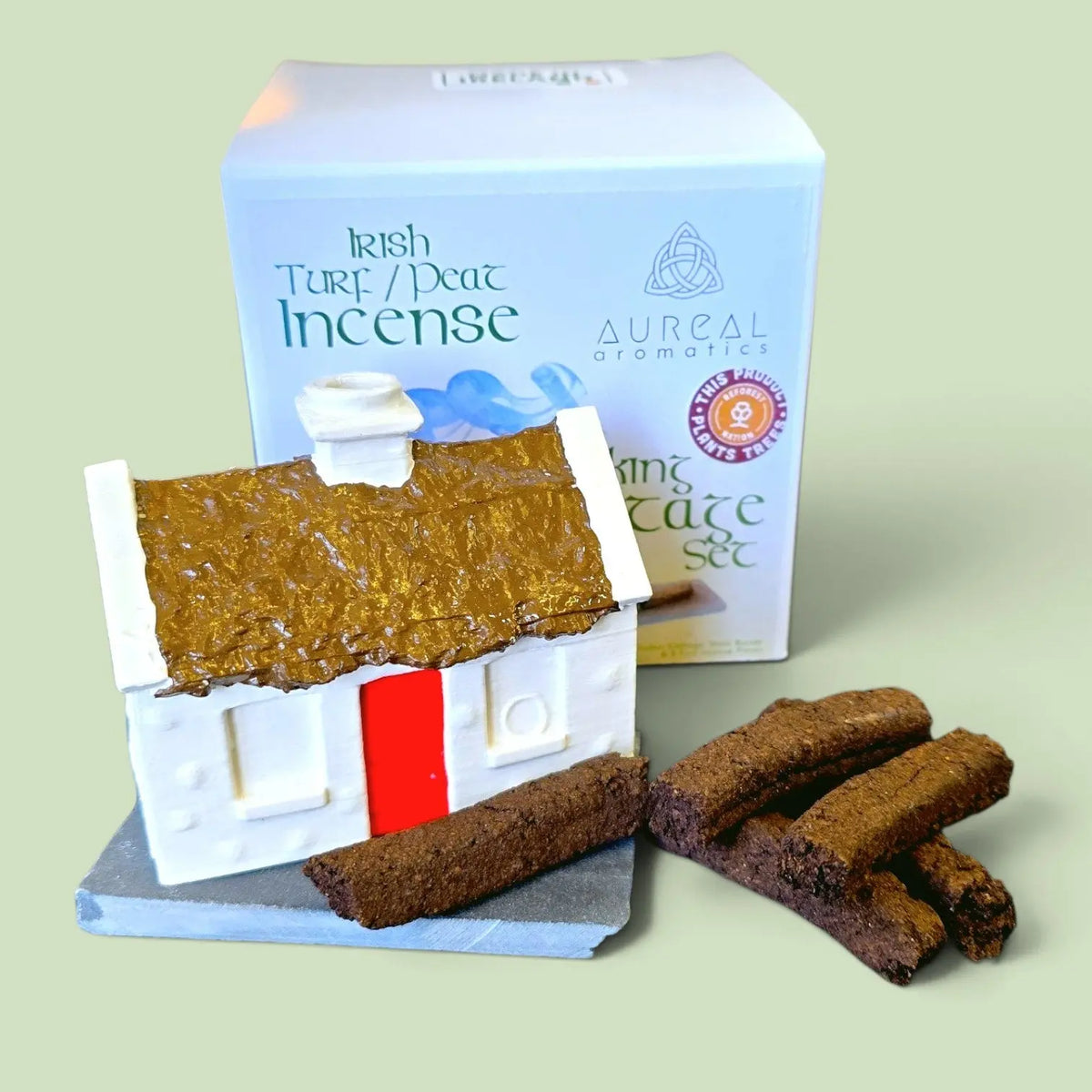 Cottage burner on a slate with turf sods, in front of the Irish Turf Peat Incense box