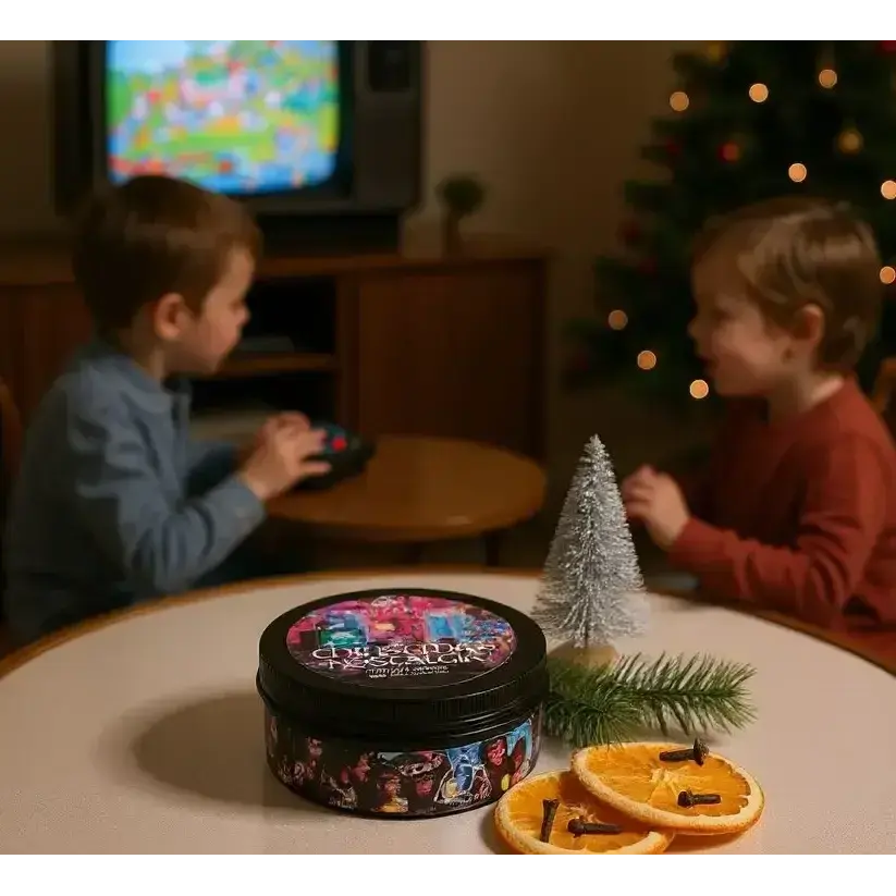 Christmas Nostalgia candle on a table with dried orange slices, two children by a TV behind