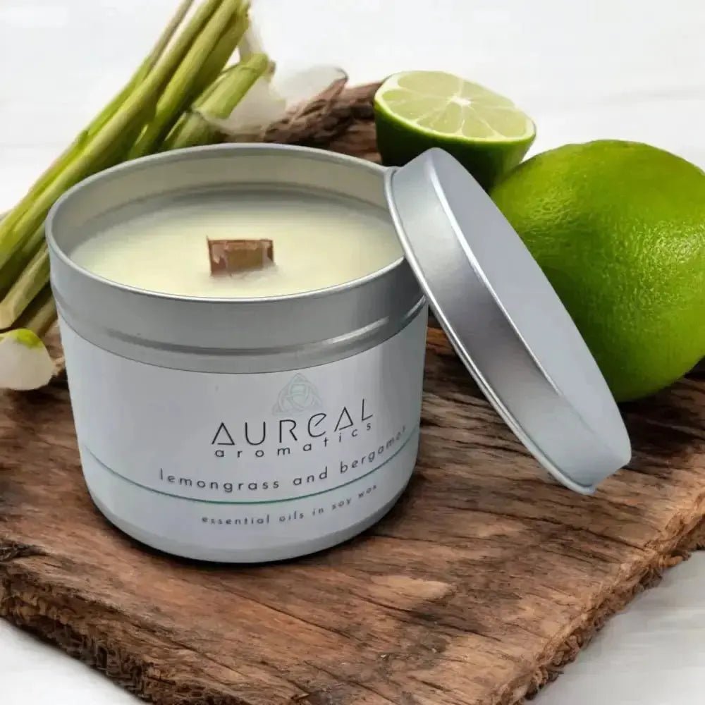 Aureal lemongrass and bergamot tin candle with a wooden wick, limes behind