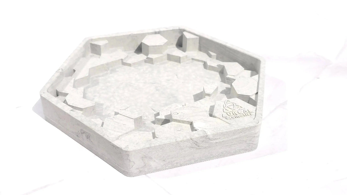 Empty grey hexagon Giant's Causeway candle base with broken column shapes around the edge