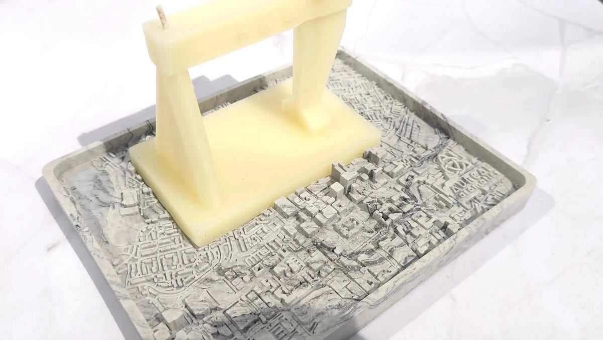 Harland and Wolff crane candle standing on its grey relief map base