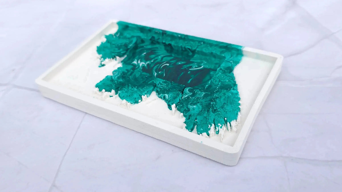 Empty white Irish cottage candle base with a green marbled pattern