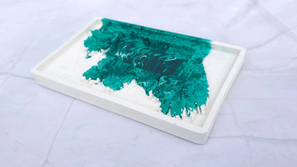 Empty white Irish cottage candle base with a green marbled pattern