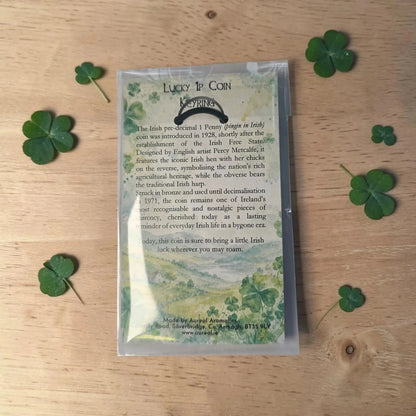 Back of the Lucky 1p Coin Keyring packet with printed text, with shamrock leaves on wood