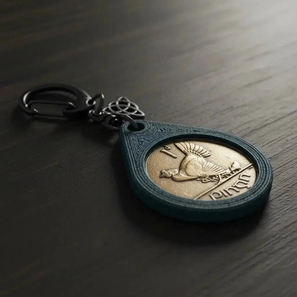Irish penny keyring with a hen design and a Celtic knot charm on a dark wooden table