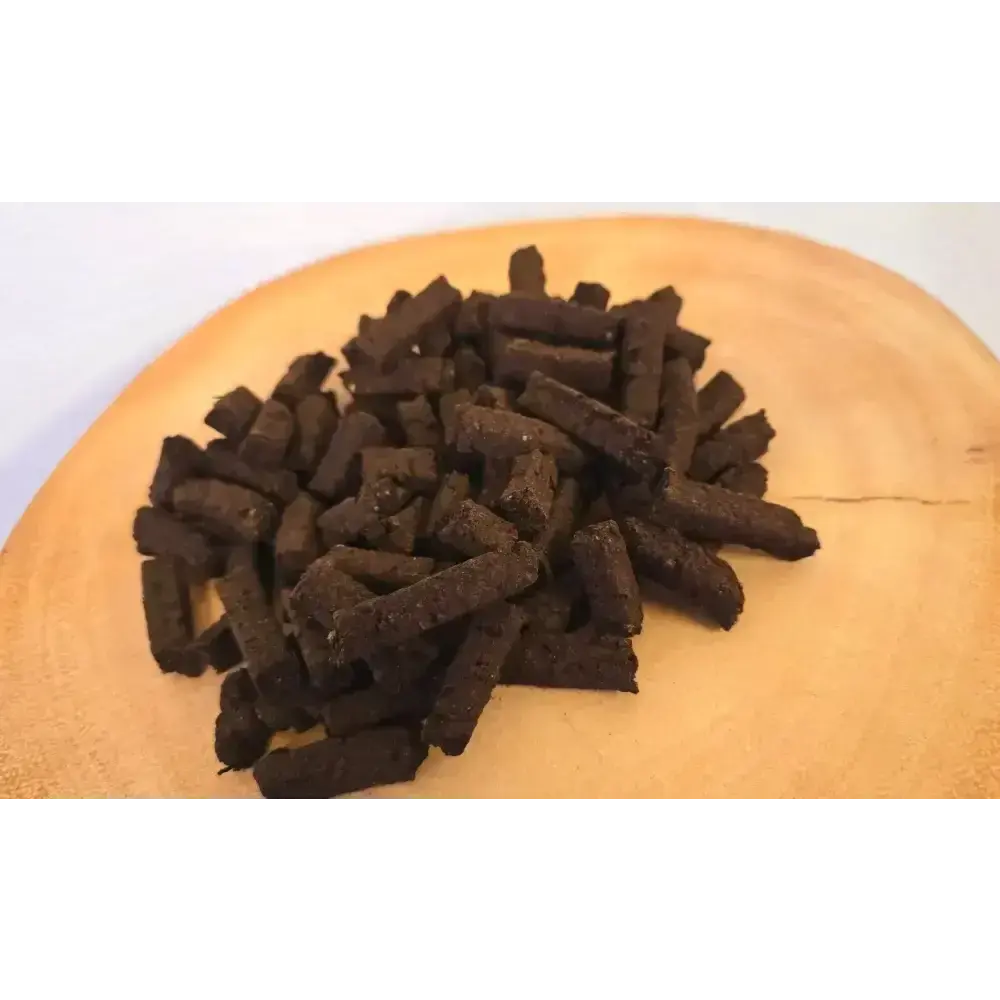 Large pile of Irish turf incense Wee Bits on a wood slice