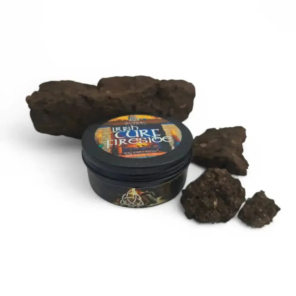 Lidded Irish Turf Fireside candle tin beside pieces of dried turf