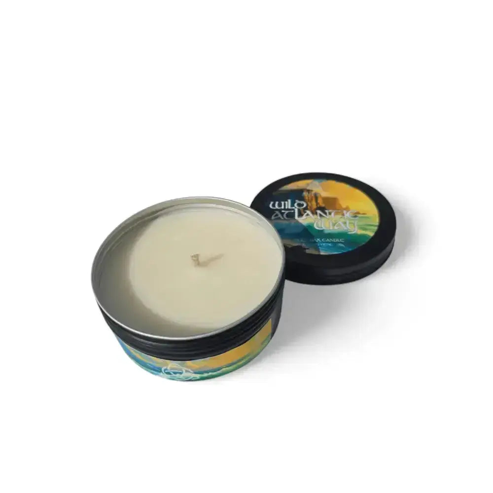 Wild Atlantic Way candle in a black tin with its lid beside it
