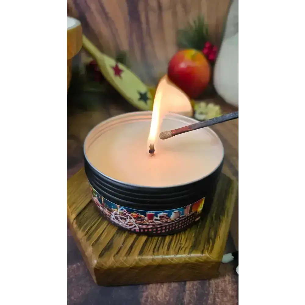 Nanny's Kitchen tin candle being lit with a match on a hexagon wooden stand