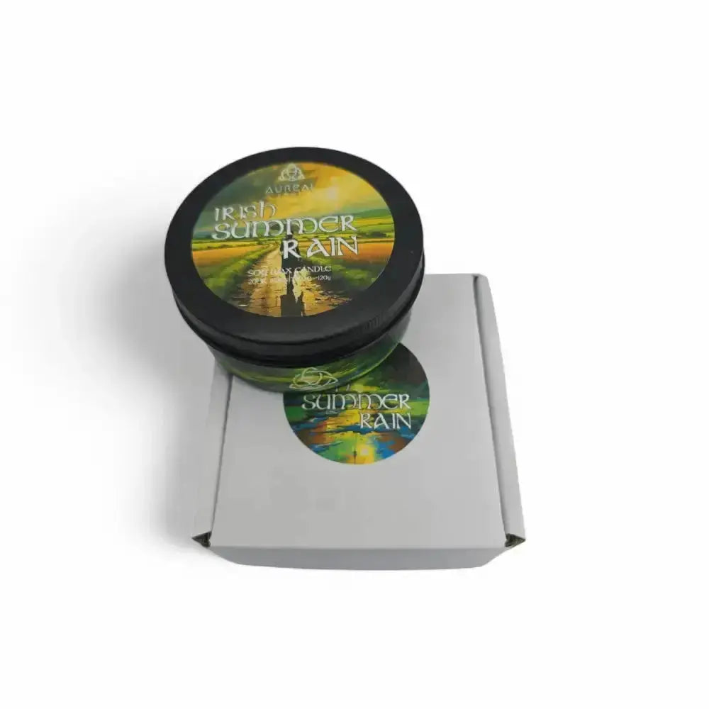 Irish Summer Rain candle tin on top of a grey mailer box with a round sticker