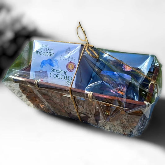 Basket wrapped in cellophane and tied with twine, holding a Smoking Cottage Set box