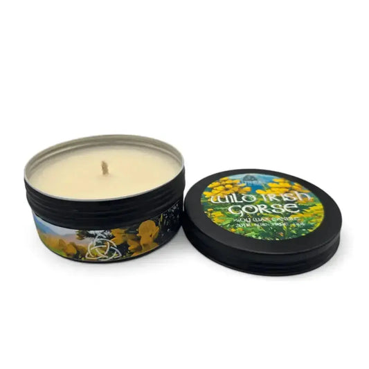 Wild Irish Gorse soy wax candle in a black tin with its lid beside it
